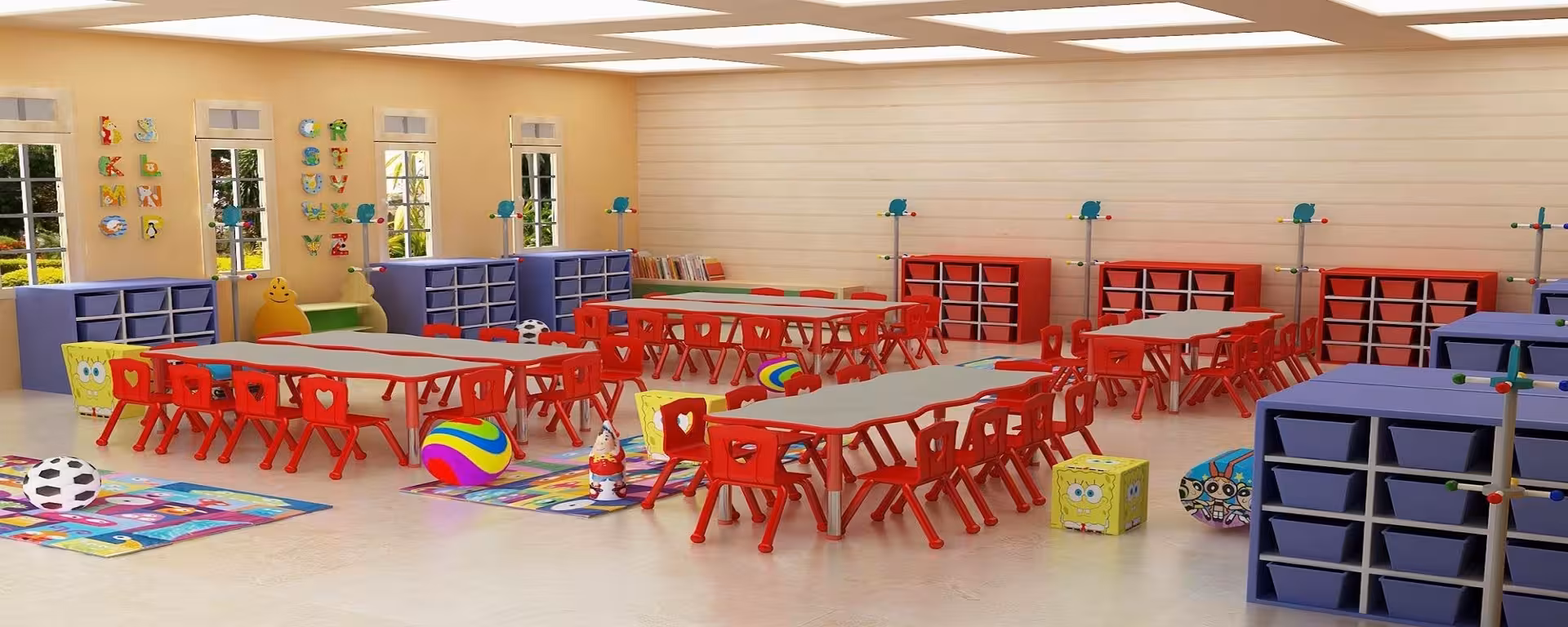 Nursery classroom with large tables, multiple chairs, bookshelf, and colorful decorations.